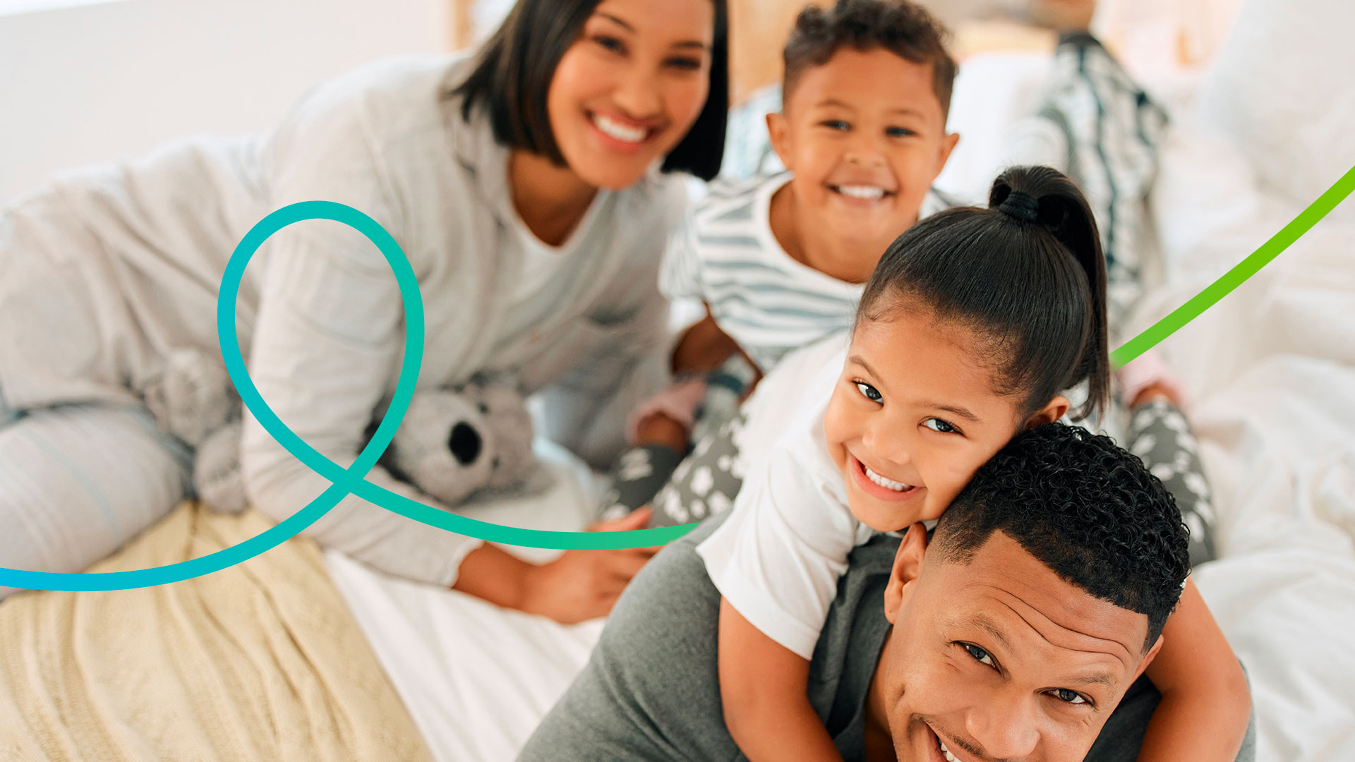 Portrait of a beautiful young family talking and bonding in bed
